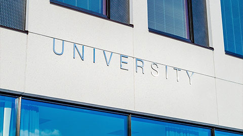 Face of a building with the word University in all caps